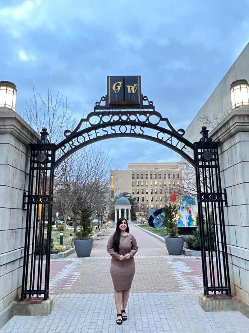 A photo of a Jaya Parashar standing under the GW gates