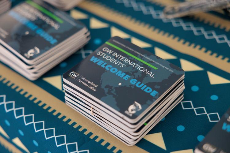 An image of a stack of New International Student Orientation Booklets