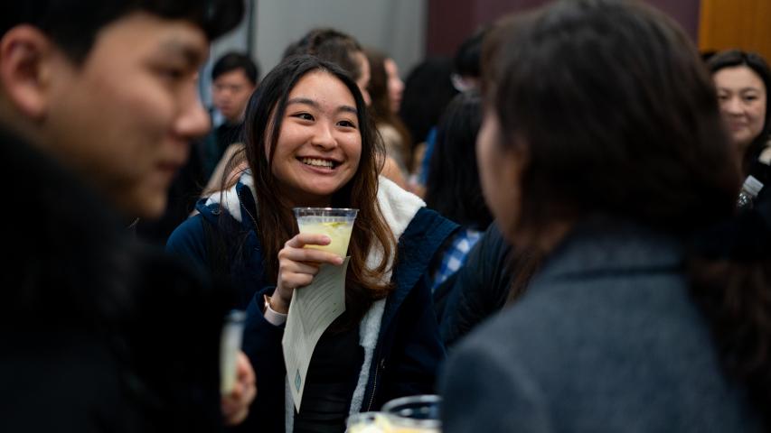 Students holding drinks and smiling