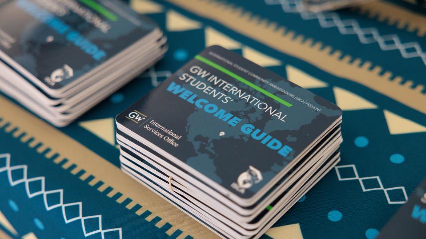 An image of a stack of New International Student Orientation Booklets